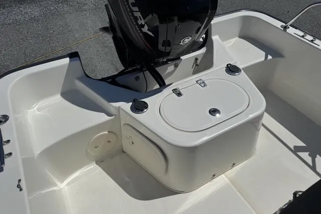 Slide: The Image of 2017 Boston Whaler 170 Montauk boat interior with engine and storage compartment. - 11