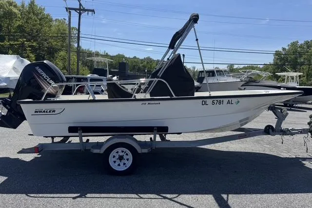 Slide: The Image of 2017 Boston Whaler 170 Montauk boat on trailer, parked outdoors. - 3