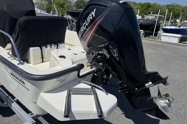 Slide: The Image of 2017 Boston Whaler 170 Montauk with Mercury outboard engine, docked at marina. - 4