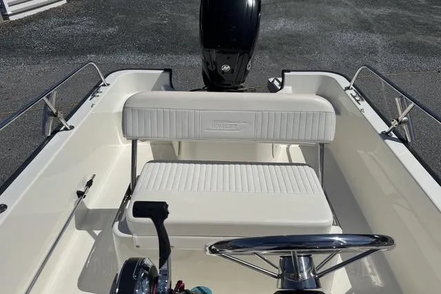 Slide: The Image of 2017 Boston Whaler 170 Montauk boat interior with steering wheel and seating. - 5