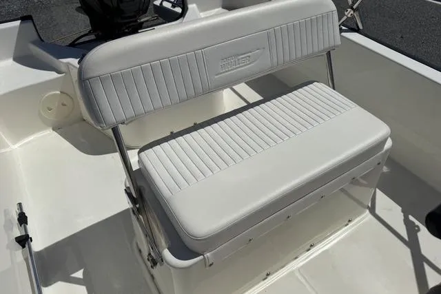Slide: The Image of 2017 Boston Whaler 170 Montauk boat interior with cushioned seating. - 7