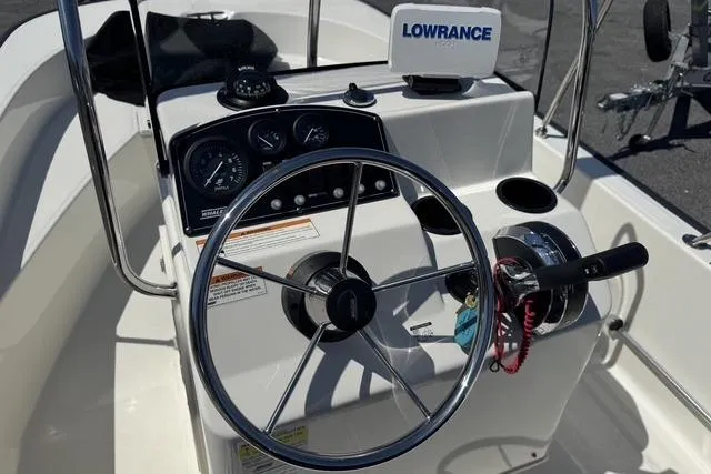 Slide: The Image of 2017 Boston Whaler 170 Montauk boat console with steering wheel and Lowrance GPS system. - 8