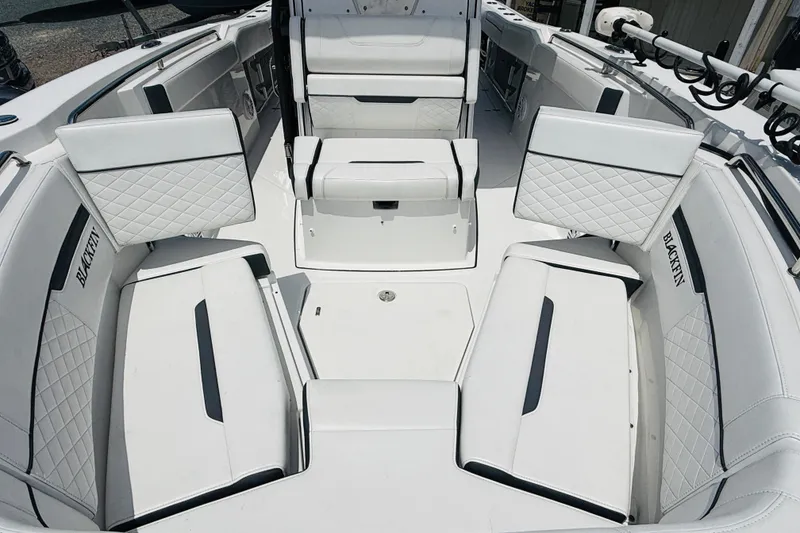 Slide: The Image of 2021 Blackfin 272 CC boat interior with white cushioned seating and sleek design. - 10