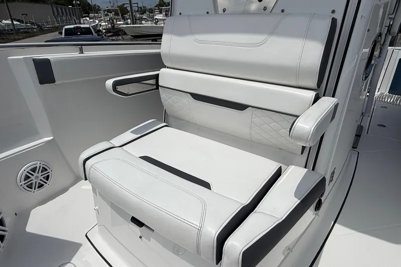 Slide: The Image of 2021 Blackfin 272 CC boat seat with white upholstery and armrests. - 12