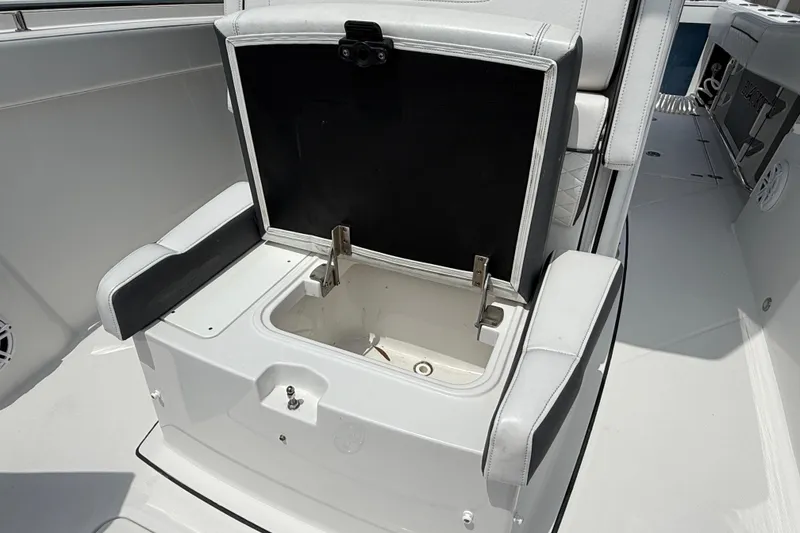 Slide: The Image of 2021 Blackfin 272 CC boat seat storage compartment open, showcasing interior space. - 13