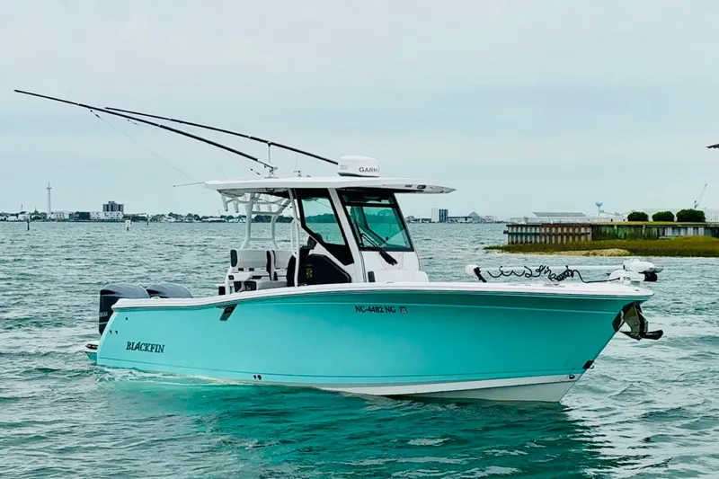 Slide: The Image of 2021 Blackfin 272 CC boat on water, featuring sleek design and vibrant color. - 2