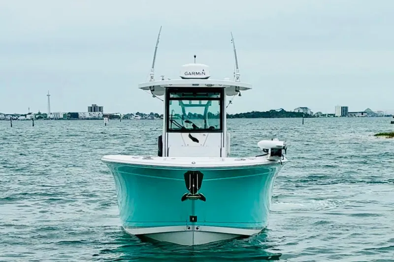 Slide: The Image of 2021 Blackfin 272 CC boat on water, front view with cityscape background. - 3