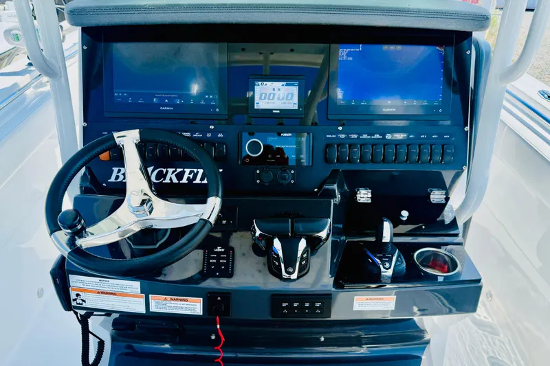 Slide: The Image of 2021 Blackfin 272 CC boat dashboard with steering wheel and electronic controls. - 8