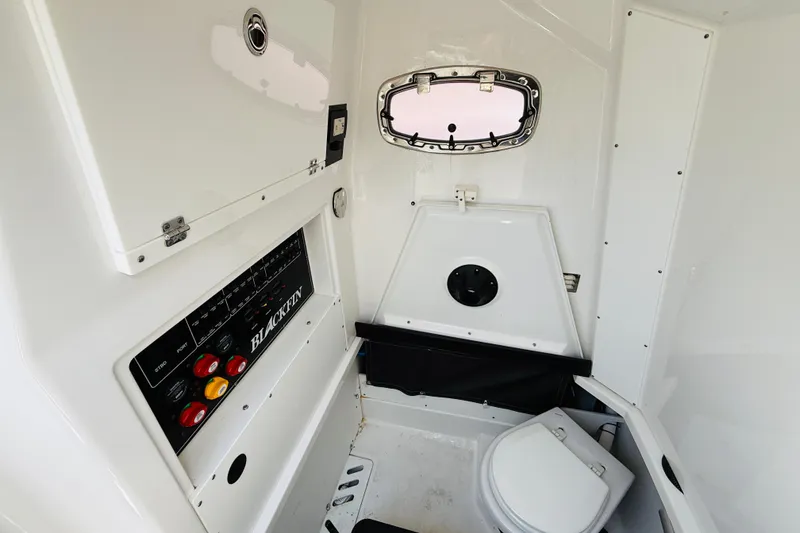 Slide: The Image of 2021 Blackfin 272 CC boat interior with control panel and compact toilet. - 9
