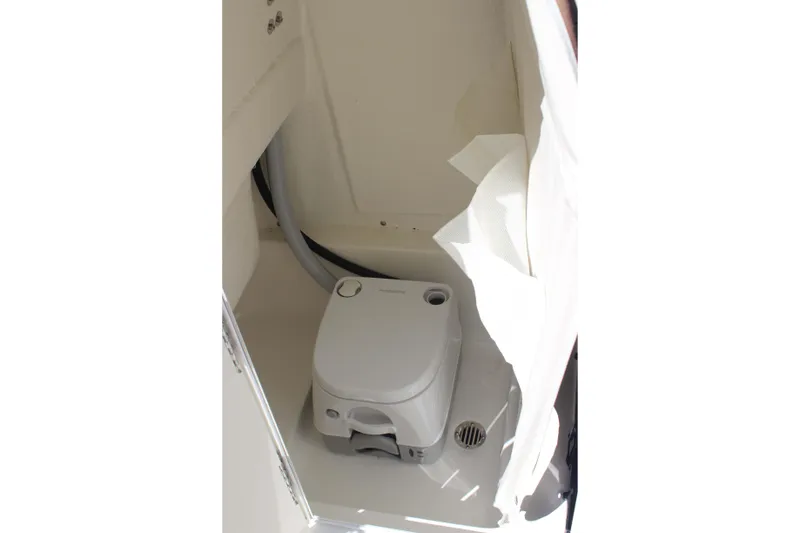 Slide: The Image of Portable toilet inside 2026 Key West 249 FS boat cabin, featuring compact design and white interior. - 16