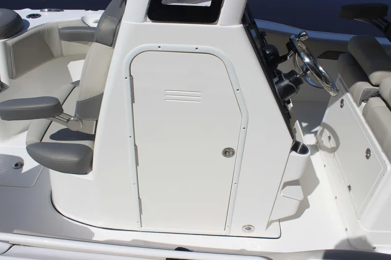 Slide: The Image of 2026 Key West 249 FS boat interior with helm, seating, and storage compartment. - 5