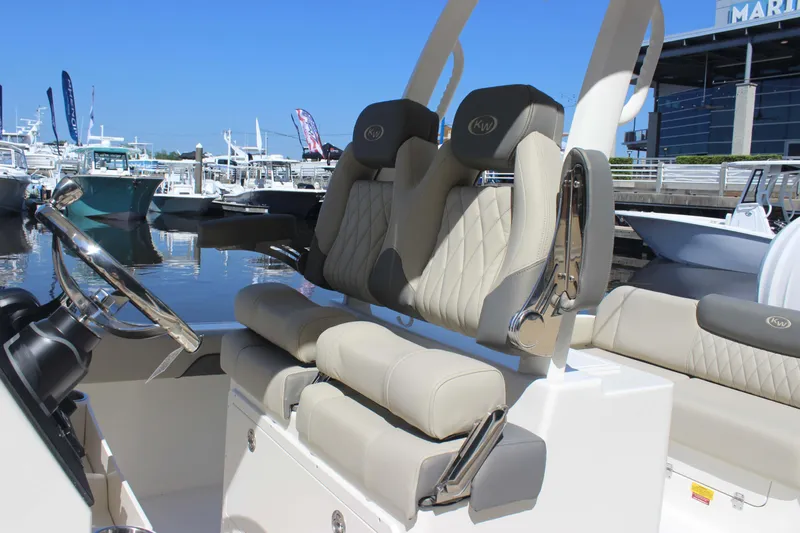 Slide: The Image of 2026 Key West 249 FS boat interior with luxurious seating and steering wheel at marina. - 8