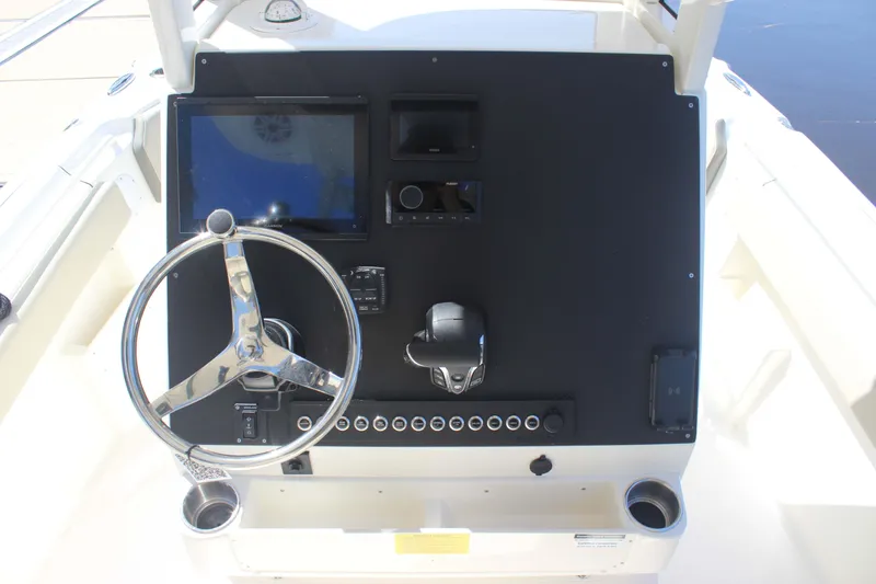 Slide: The Image of 2026 Key West 249 FS boat dashboard with steering wheel and control panel. - 9