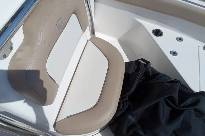 Slide: The Image of 2015 Key West 203 FS boat seat with beige upholstery and black cover. - 14