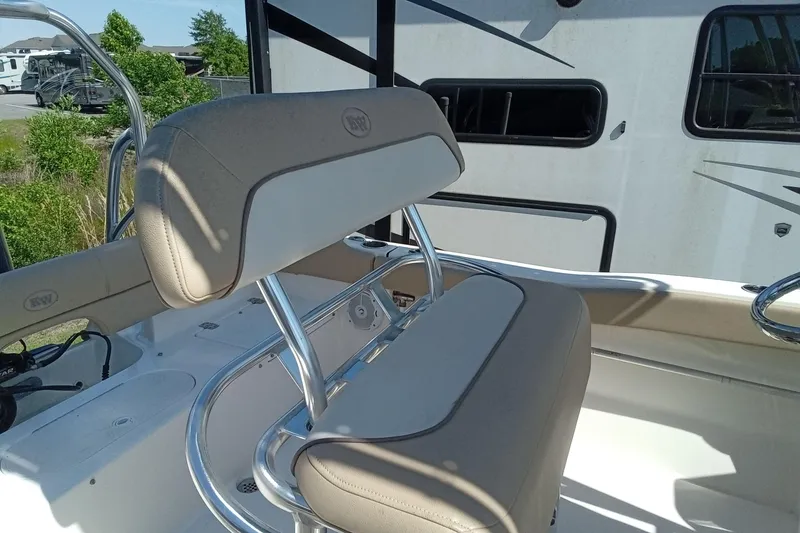 Slide: The Image of 2015 Key West 203 FS boat seating with beige upholstery and stainless steel frame. - 17