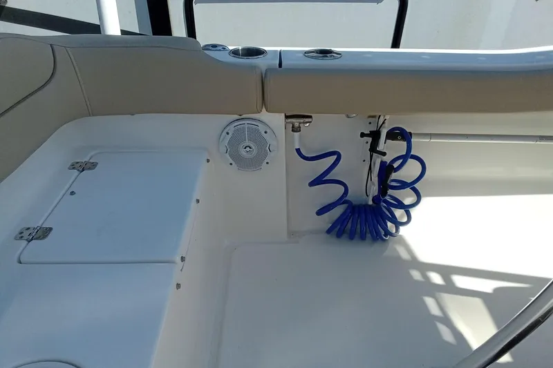 Slide: The Image of Interior of a 2015 Key West 203 FS boat featuring seating and a coiled blue hose. - 21