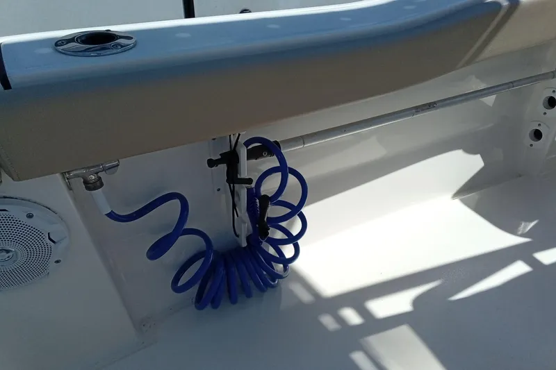 Slide: The Image of 2015 Key West 203 FS boat interior with blue coiled hose and speaker. - 22