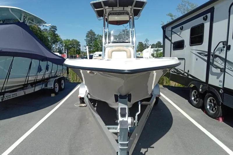 Slide: The Image of 2015 Key West 203 FS boat on trailer, parked between other vehicles. - 35