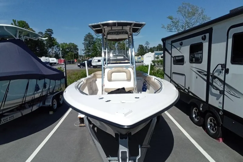 Slide: The Image of 2015 Key West 203 FS boat parked between trailers in a sunny outdoor setting. - 36