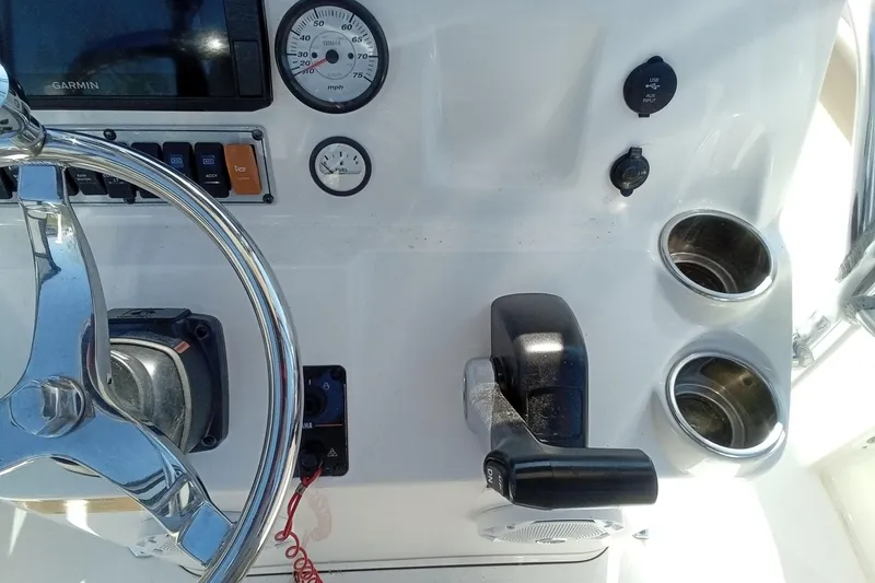 Slide: The Image of 2015 Key West 203 FS boat dashboard with steering wheel, gauges, and controls. - 8