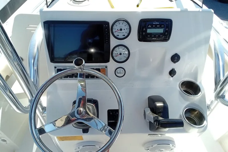 Slide: The Image of 2015 Key West 203 FS boat dashboard with steering wheel and gauges. - 9