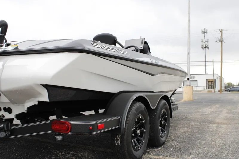 Slide: The Image of 2026 Skeeter ZXE21 boat on trailer, showcasing sleek design and dual-axle wheels. - 10