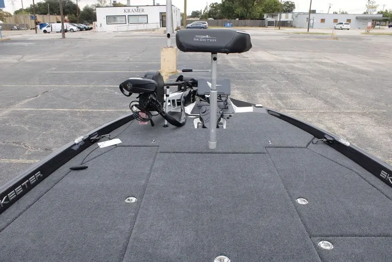 Slide: The Image of 2026 Skeeter ZXE21 fishing boat with advanced trolling motor in a parking lot. - 14