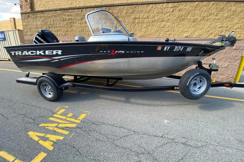 The Image of 2011 Tracker Pro Guide V-175 Combo boat on trailer, parked outdoors. - 0