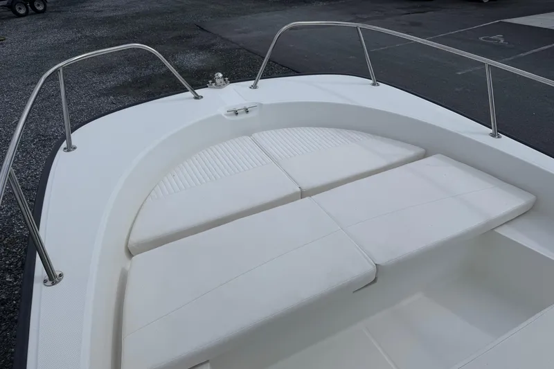 Slide: The Image of 2018 Boston Whaler 210 Montauk boat bow with cushioned seating and stainless steel railings. - 10