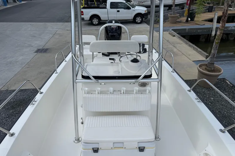 Slide: The Image of 2018 Boston Whaler 210 Montauk boat interior with seating and console, dockside view. - 11