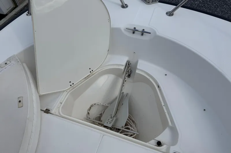 Slide: The Image of Open anchor storage on 2018 Boston Whaler 210 Montauk boat, showing anchor and rope. - 12