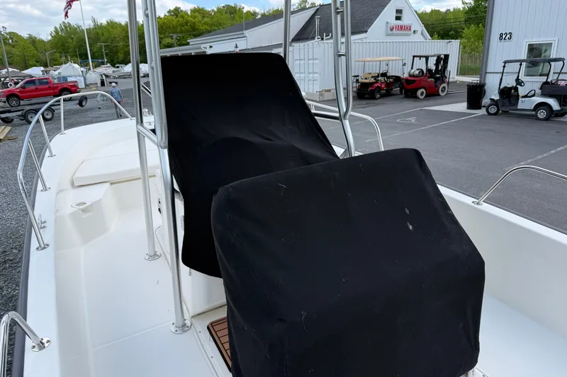 Slide: The Image of 2018 Boston Whaler 210 Montauk boat interior with covered console and seating. - 13