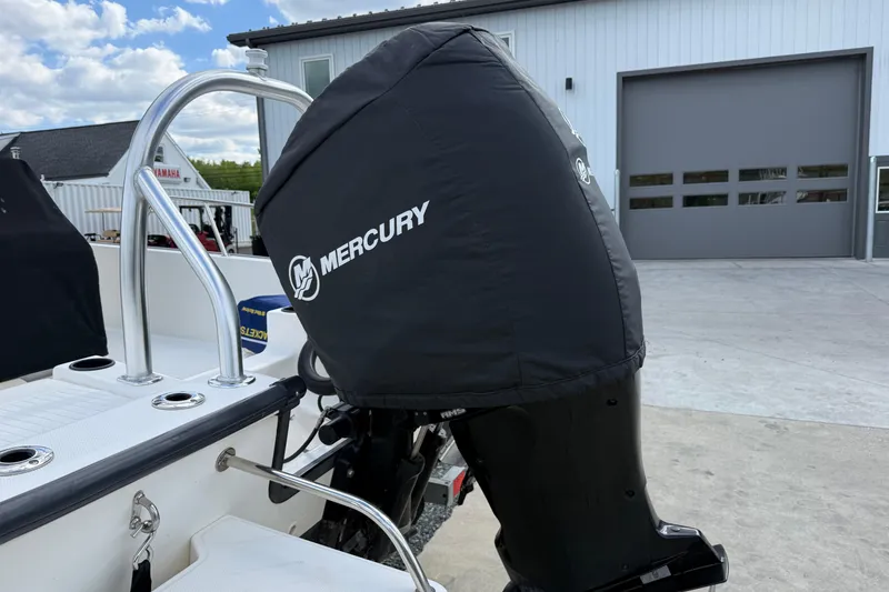 Slide: The Image of 2018 Boston Whaler 210 Montauk with Mercury engine cover, parked outdoors. - 14