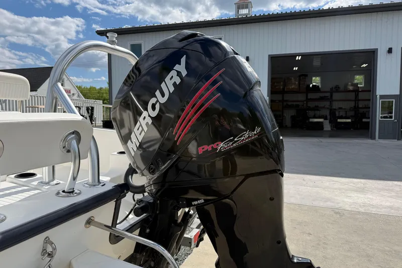 Slide: The Image of 2018 Boston Whaler 210 Montauk with Mercury Pro FourStroke engine, parked outside a garage. - 5