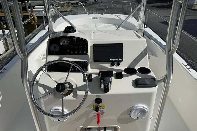 Slide: The Image of 2018 Boston Whaler 210 Montauk boat console with steering wheel and navigation equipment. - 6