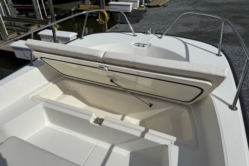 Slide: The Image of 2018 Boston Whaler 210 Montauk boat with open storage compartment at dock. - 8