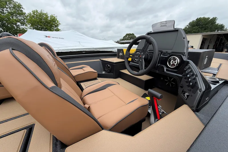Slide: The Image of 2026 Xpress H18C Crappie boat interior with tan seats and modern dashboard. - 2