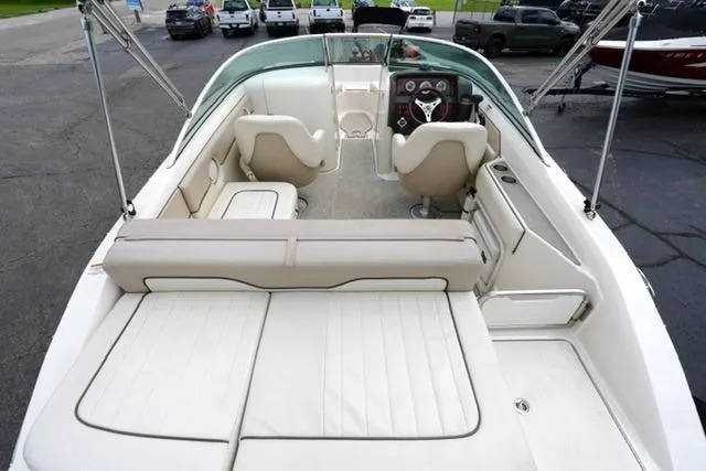 Slide: The Image of 2010 Sea Ray 220 Sundeck boat interior with seating and steering wheel. - 12