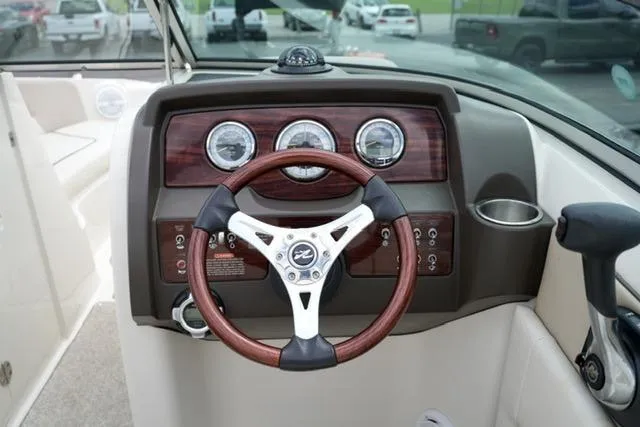 Slide: The Image of Steering console of 2010 Sea Ray 220 Sundeck with wood accents and gauges. - 14