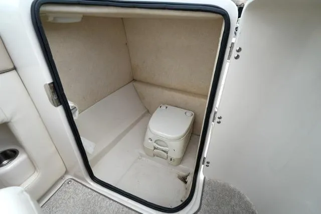 Slide: The Image of Interior view of a 2010 Sea Ray 220 Sundeck boat's compact bathroom area. - 15