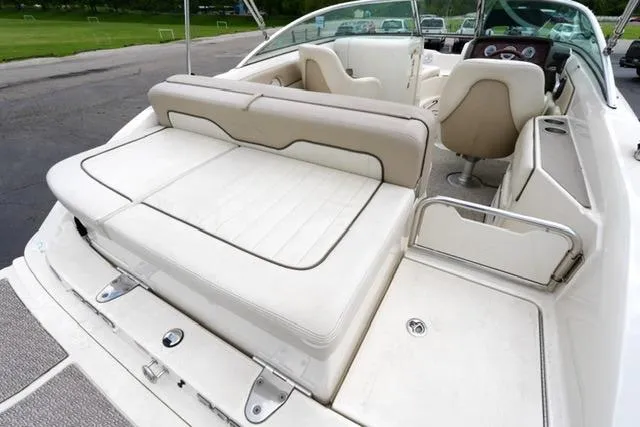 Slide: The Image of 2010 Sea Ray 220 Sundeck boat interior with white seating and dashboard view. - 17