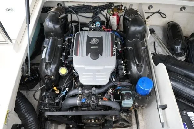 Slide: The Image of Engine compartment of a 2010 Sea Ray 220 Sundeck boat, showcasing the powerful motor. - 18
