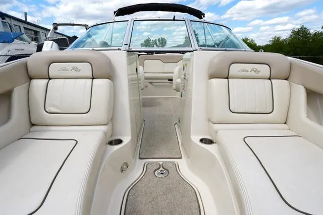 Slide: The Image of 2010 Sea Ray 220 Sundeck interior with beige seating and open deck view. - 9