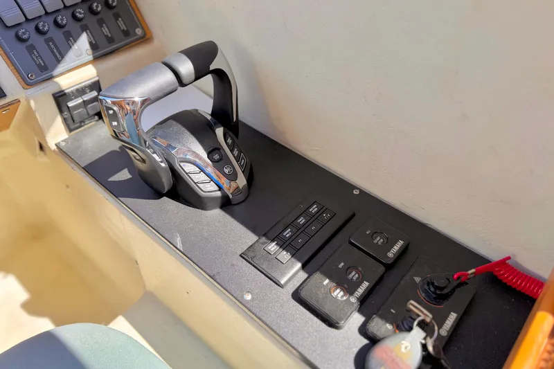 Slide: The Image of 1970 Bertram boat control panel with Yamaha throttle and switches. - 14