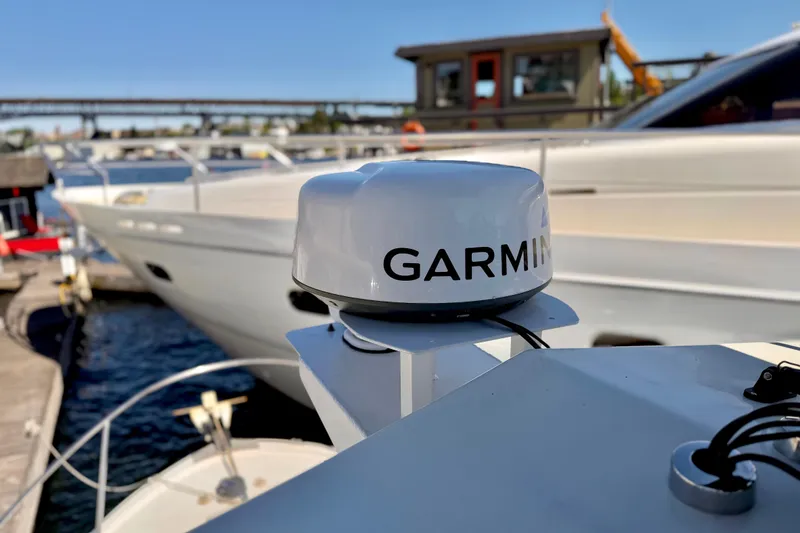 Slide: The Image of Garmin marine radar on a 1970 Bertram boat docked at a marina. - 20
