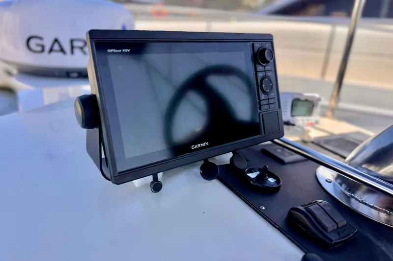 Slide: The Image of Garmin GPS device on 1970 Bertram boat dashboard, close-up view. - 21