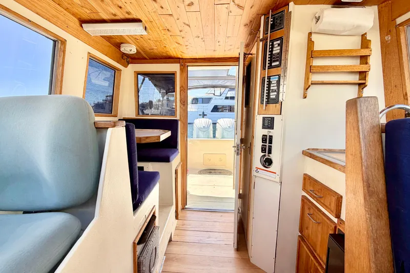 Slide: The Image of Interior of a 1970 Bertram boat with wooden accents and seating area. - 5