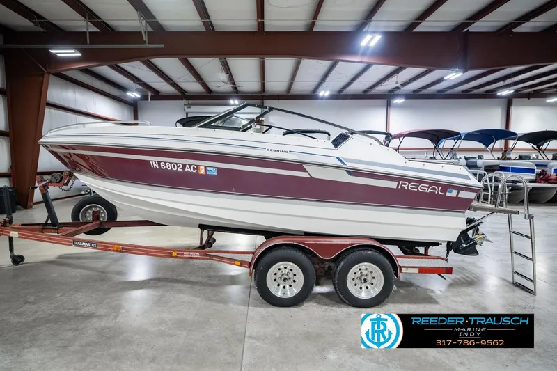 Slide: The Image of 1986 Regal Sebring 195 boat on trailer in indoor showroom. - 10