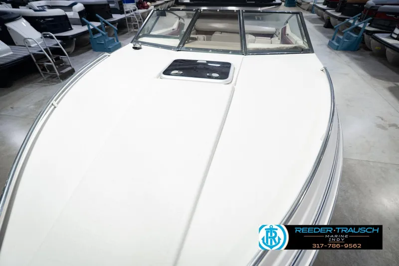 Slide: The Image of 1986 Regal Sebring 195 boat in showroom, featuring sleek white deck and windshield. - 12