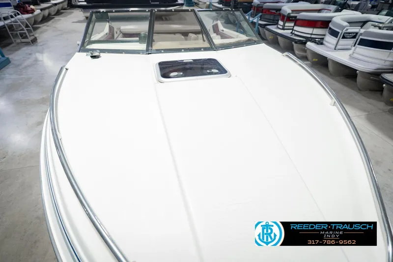 Slide: The Image of 1986 Regal Sebring 195 boat displayed indoors at a marine dealership. - 13